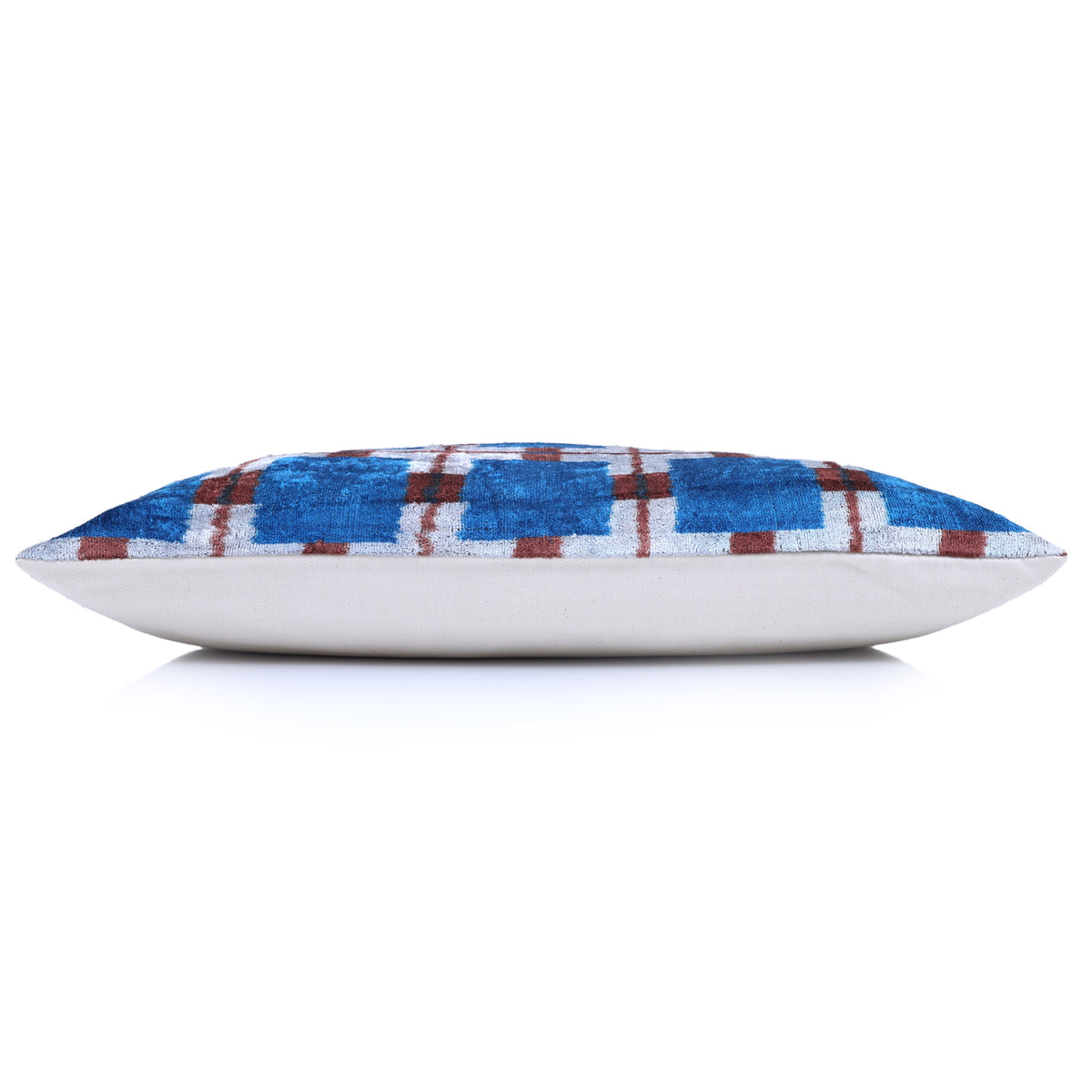 Side profile showing the thickness of the plaid silk velvet lumbar pillow and linen backing