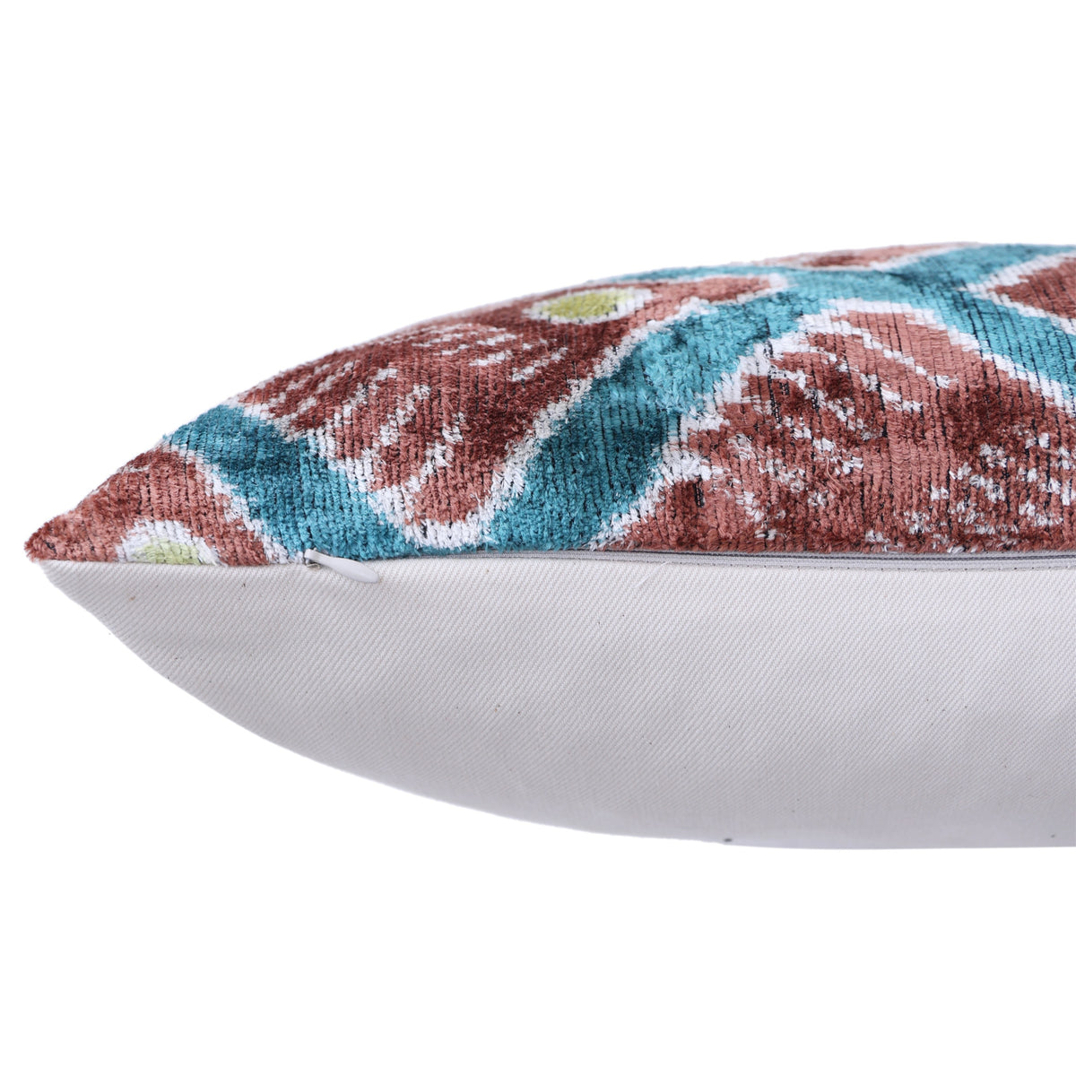 Side edge of geometric lumbar pillow showing hidden zipper and solid backing