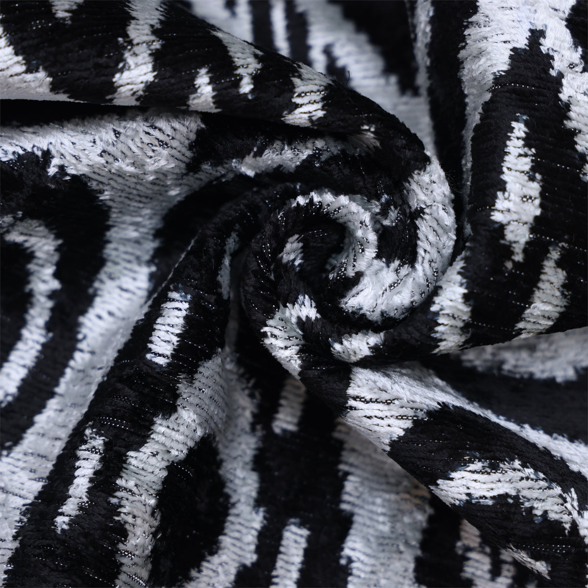 Close-up of silvery white and jet black ikat velvet showing cut-pile texture