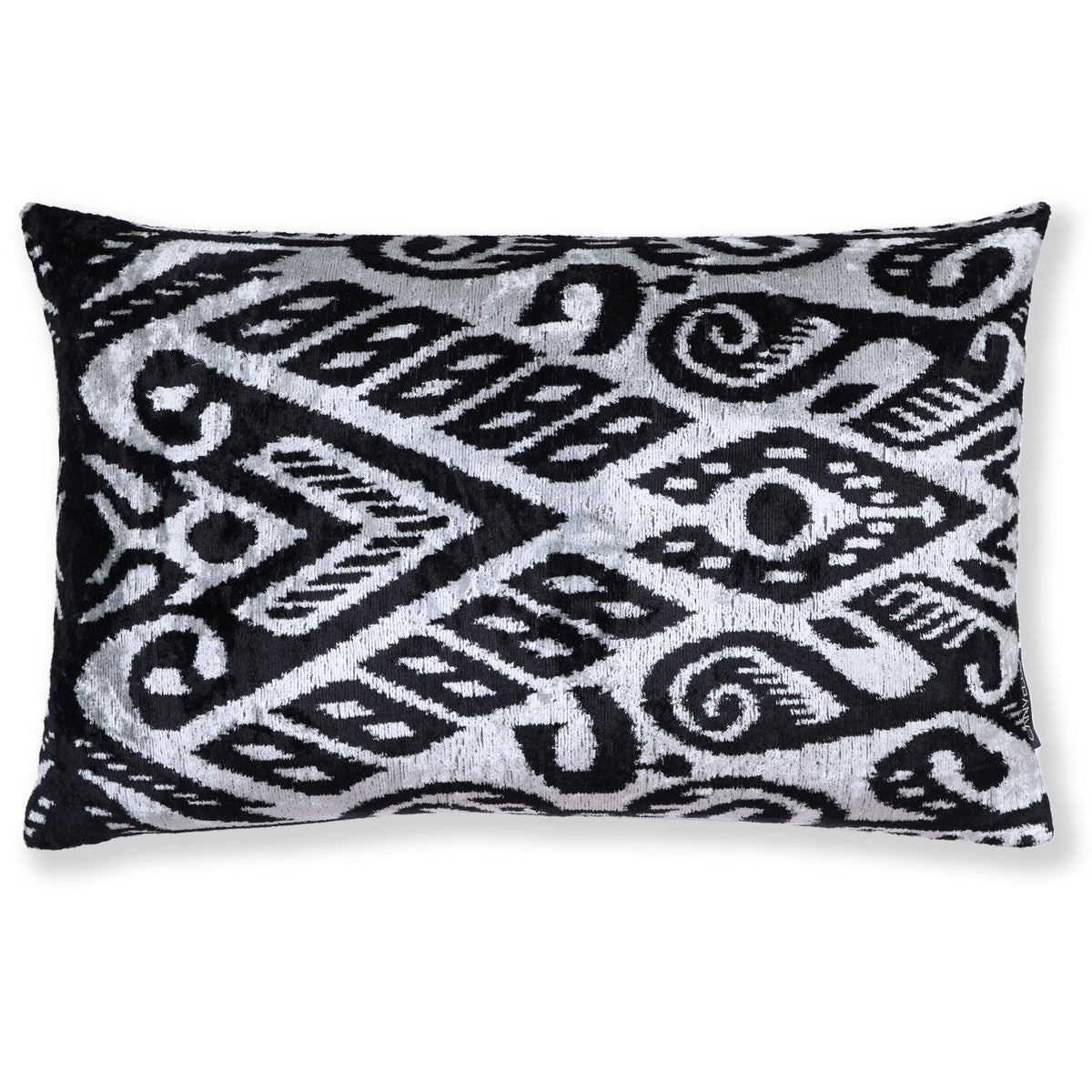 Front view of a silvery white and jet black ikat geometric lumbar pillow on white
