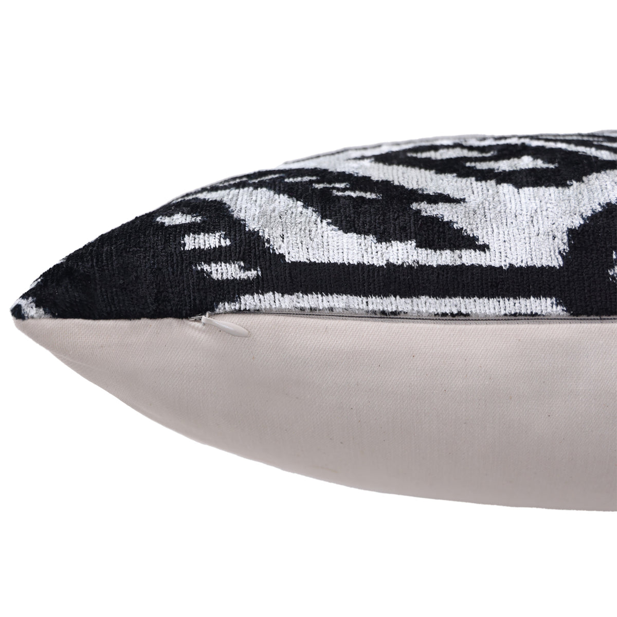 Side edge of a silvery white and jet black pillow with concealed zipper