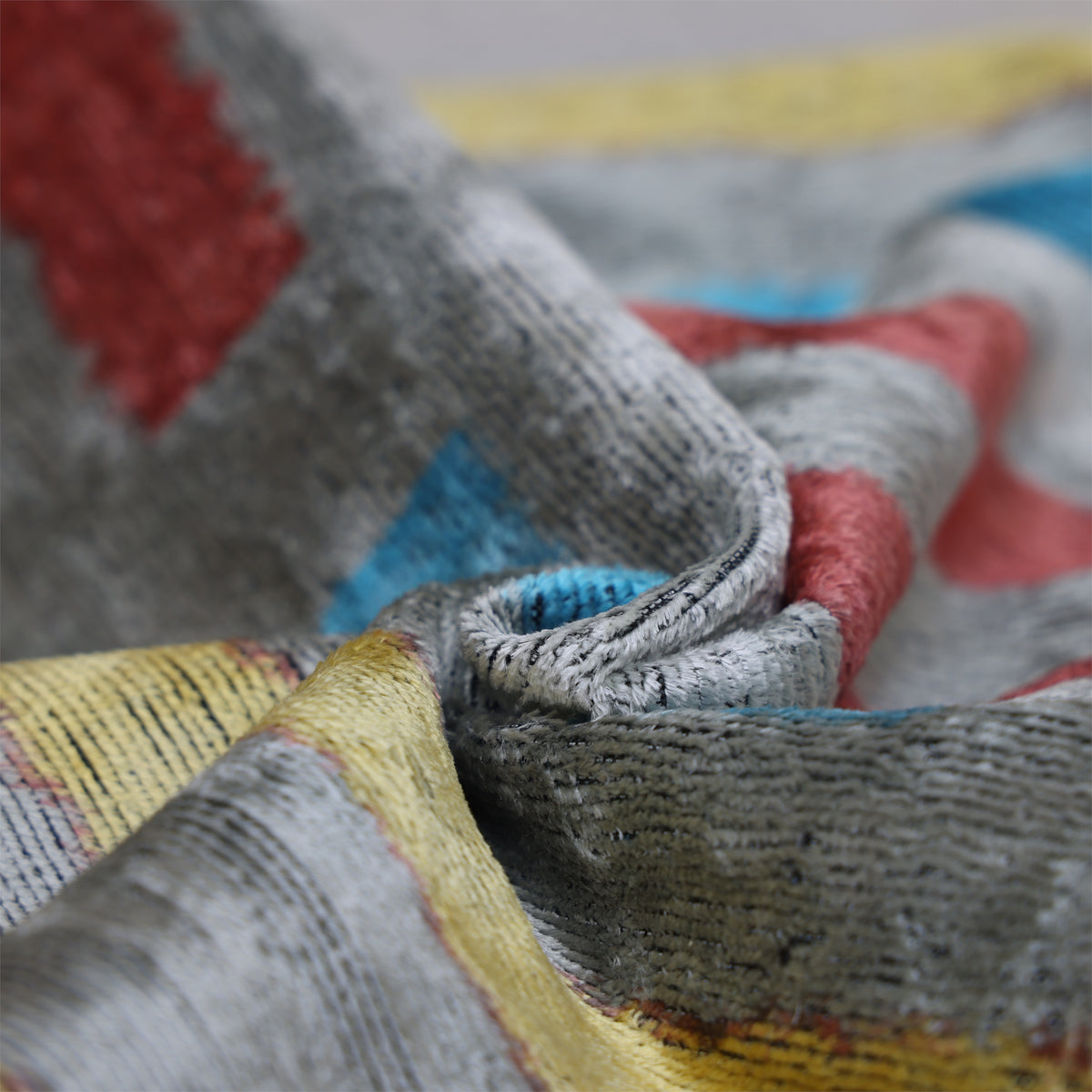 Folded silver gray cut velvet showing ribbed texture and changing sheen