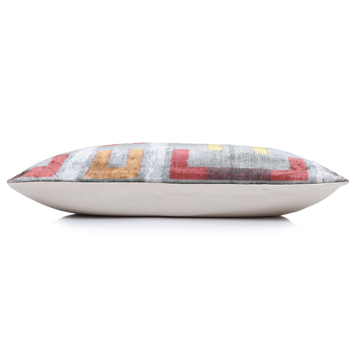 Bottom edge profile of silver gray lumbar pillow with linen backing and visible thickness