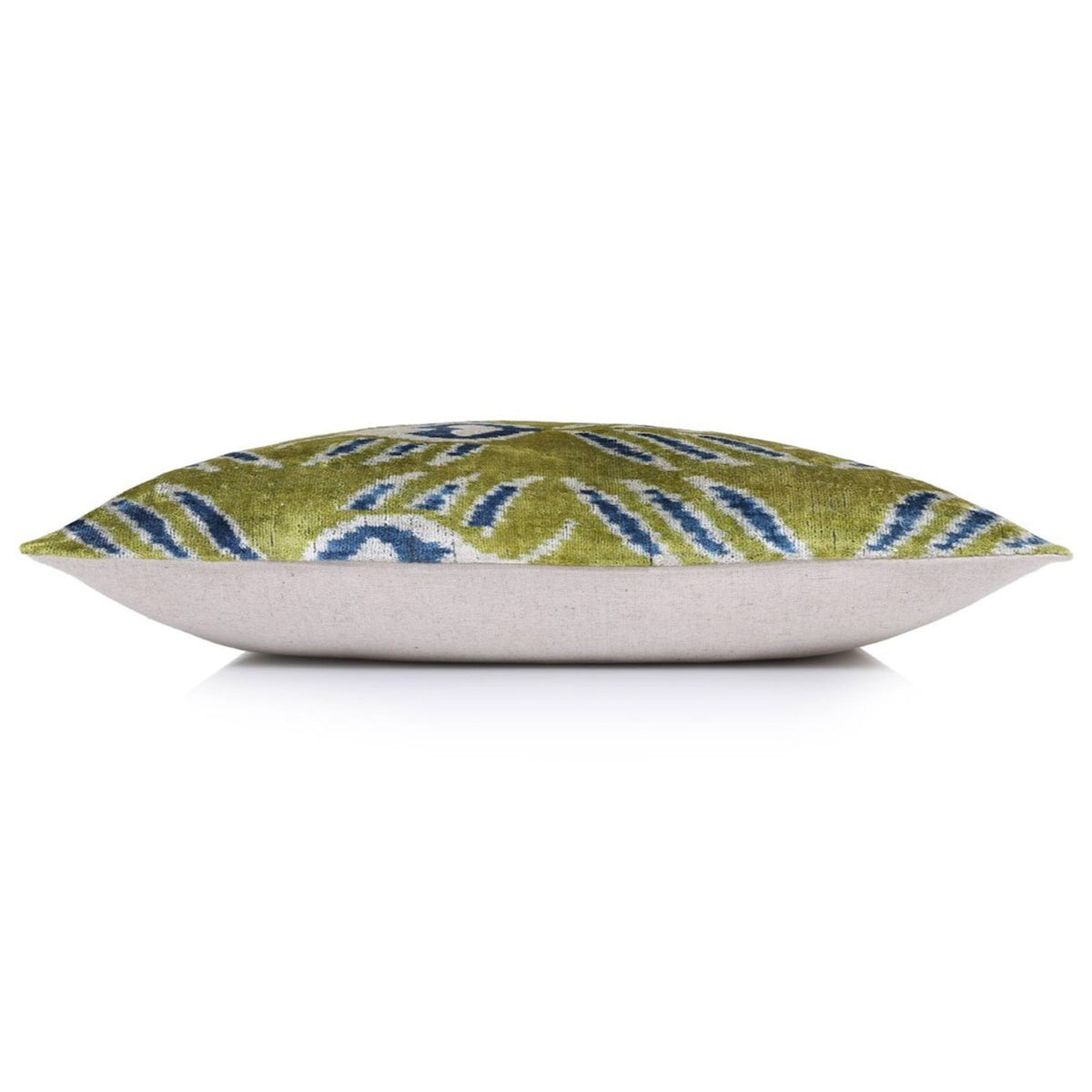 Side profile showing the full square pillow, velvet front and plain backing