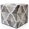 Cube-shaped ottoman with geometric pattern on a white background