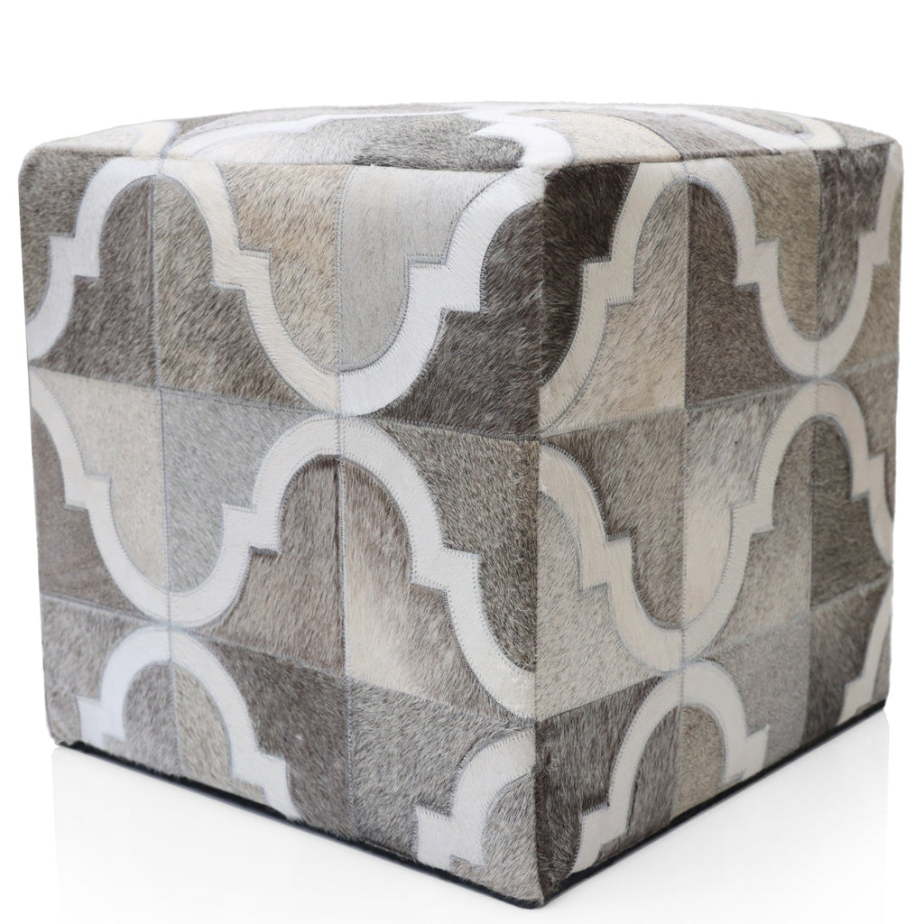 Cube-shaped ottoman with geometric pattern on a white background